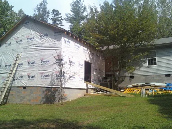 Tyvek wrapped gable on a new room addition beside an existing home in New Stanton